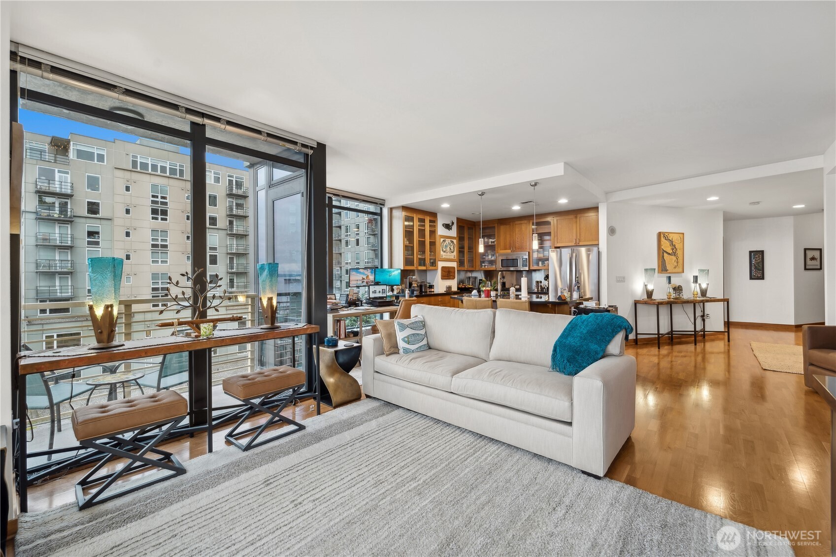2716 Elliott Avenue, Unit 800 Seattle, WA 98121 - Photo 11 of 40 a living room with furniture a wooden floor and a large window