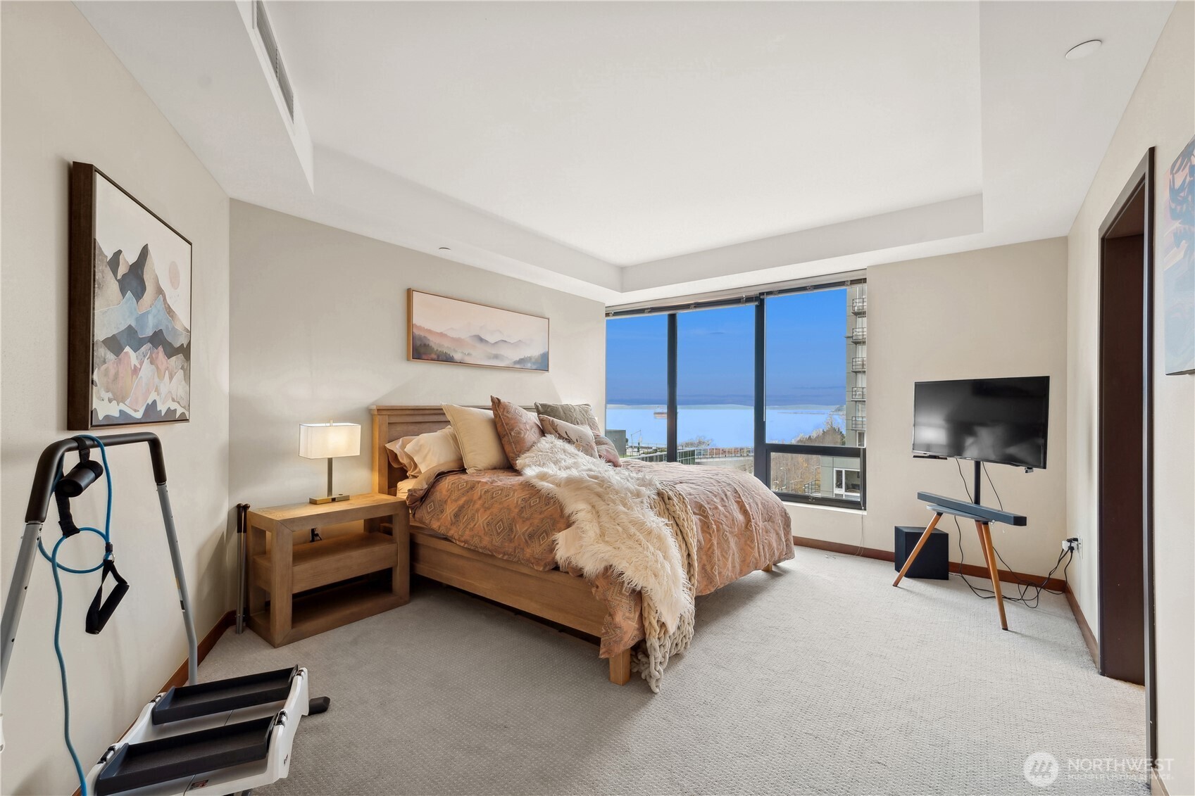 2716 Elliott Avenue, Unit 800 Seattle, WA 98121 - Photo 19 of 40 a spacious bedroom with a bed and a flat screen tv