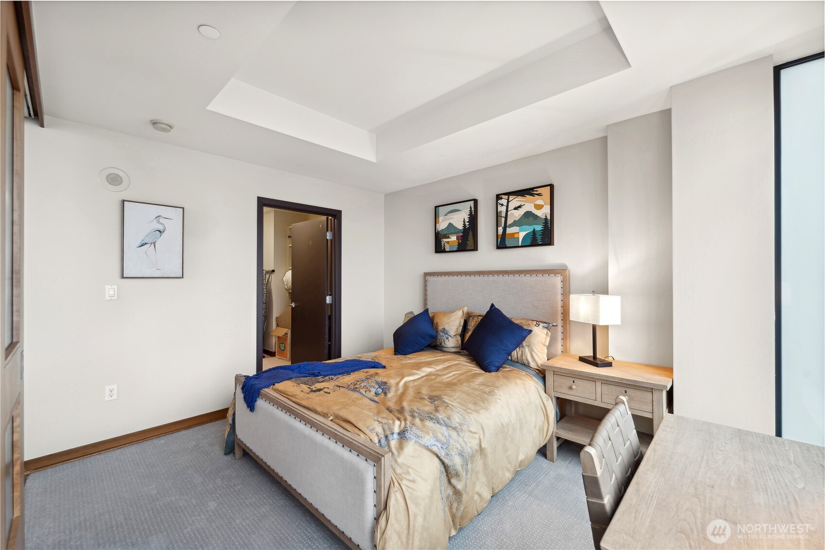 2716 Elliott Avenue, Unit 800 Seattle, WA 98121 - Photo 23 of 40 a bedroom with a large bed and a chandelier