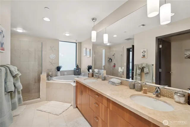 a bathroom with a tub a sink and mirror