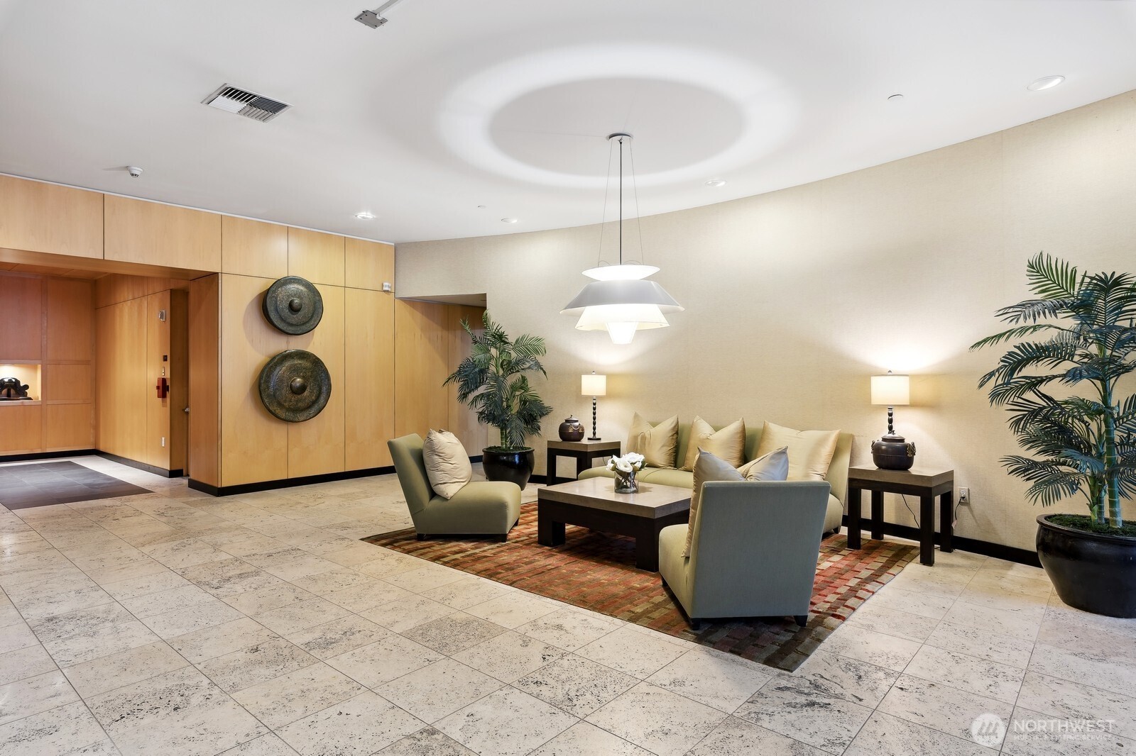 2716 Elliott Avenue, Unit 800 Seattle, WA 98121 - Photo 33 of 40 a living room with couches and kitchen view with wooden floor