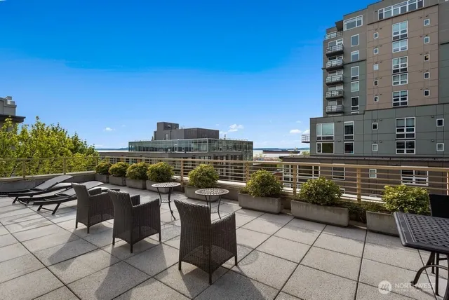 a backyard of a house with barbeque oven table and chairs
