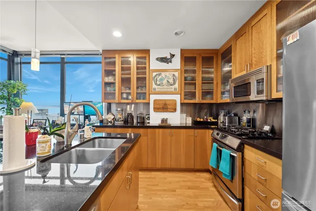 a kitchen filled a sink a counter and cabinets