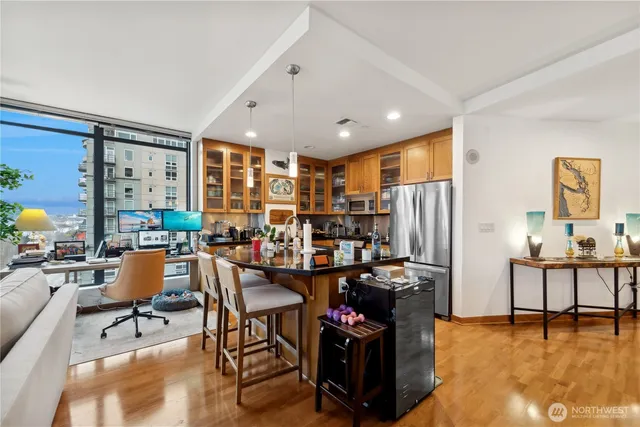 a living room with lots of furniture and a refrigerator