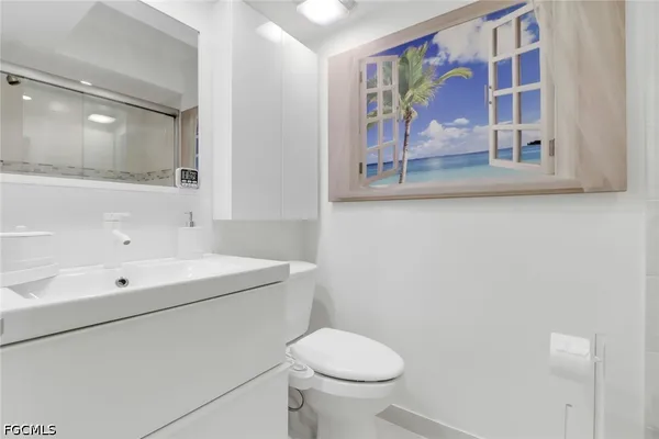 a bathroom with a sink a mirror and a toilet