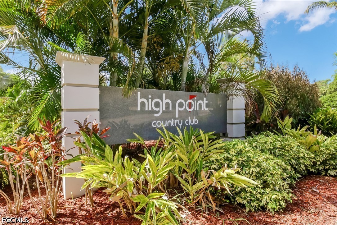 9 High Point Circle North, Unit 102 Naples, FL 34103 - Photo 26 of 48 a sign that is sitting in front of a tree