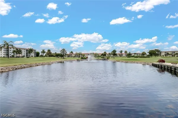 a view of a lake with houses in the background
