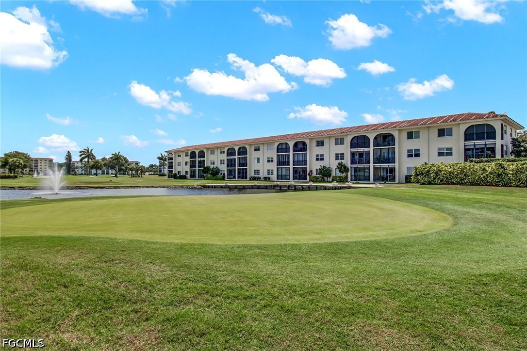 9 High Point Circle North, Unit 102 Naples, FL 34103 - Photo 32 of 48 a view of a house with a big yard