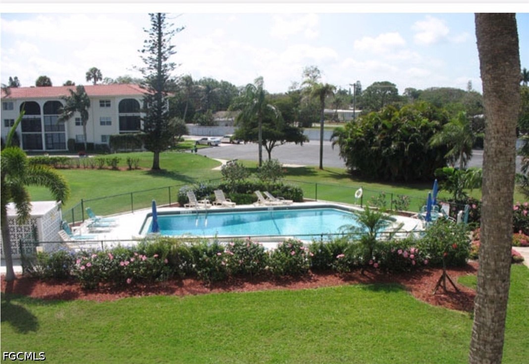 9 High Point Circle North, Unit 102 Naples, FL 34103 - Photo 40 of 48 a view of a garden with a building in the background
