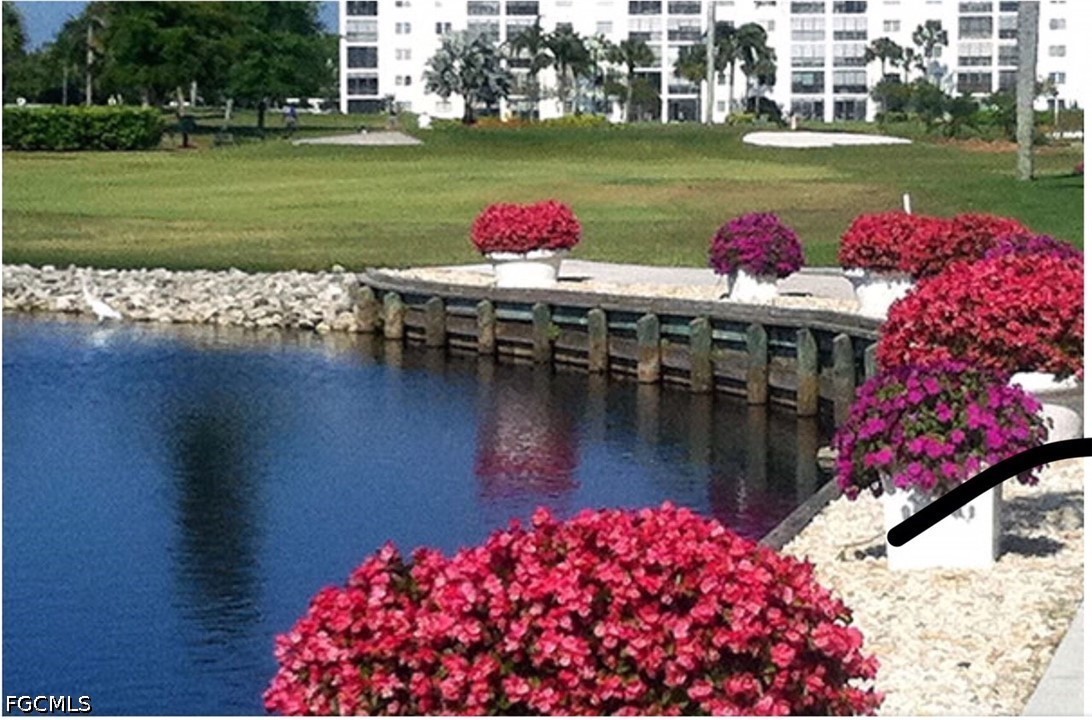 9 High Point Circle North, Unit 102 Naples, FL 34103 - Photo 41 of 48 a view of a lake and a yard