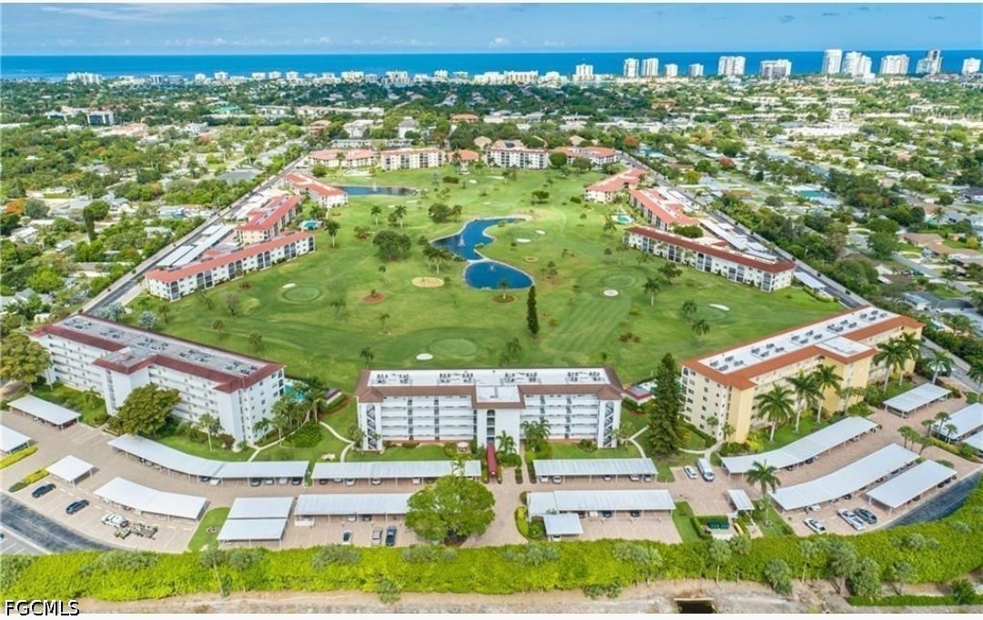 9 High Point Circle North, Unit 102 Naples, FL 34103 - Photo 44 of 48 an aerial view of residential houses with outdoor space and street view