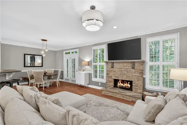 a living room with furniture a fireplace and a flat screen tv