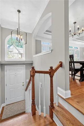 a view of a hallway with chandelier and entryway