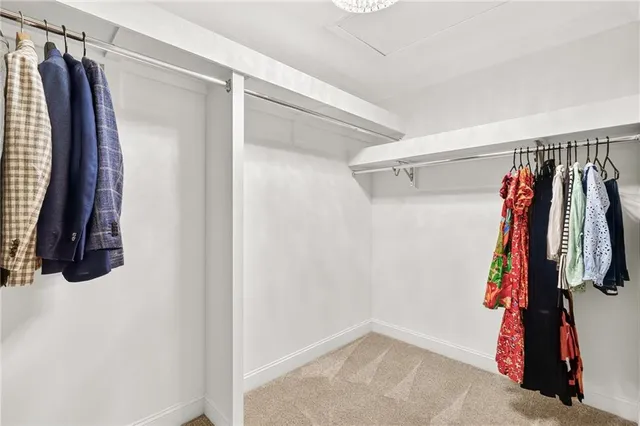 a view of walk in closet with clothes