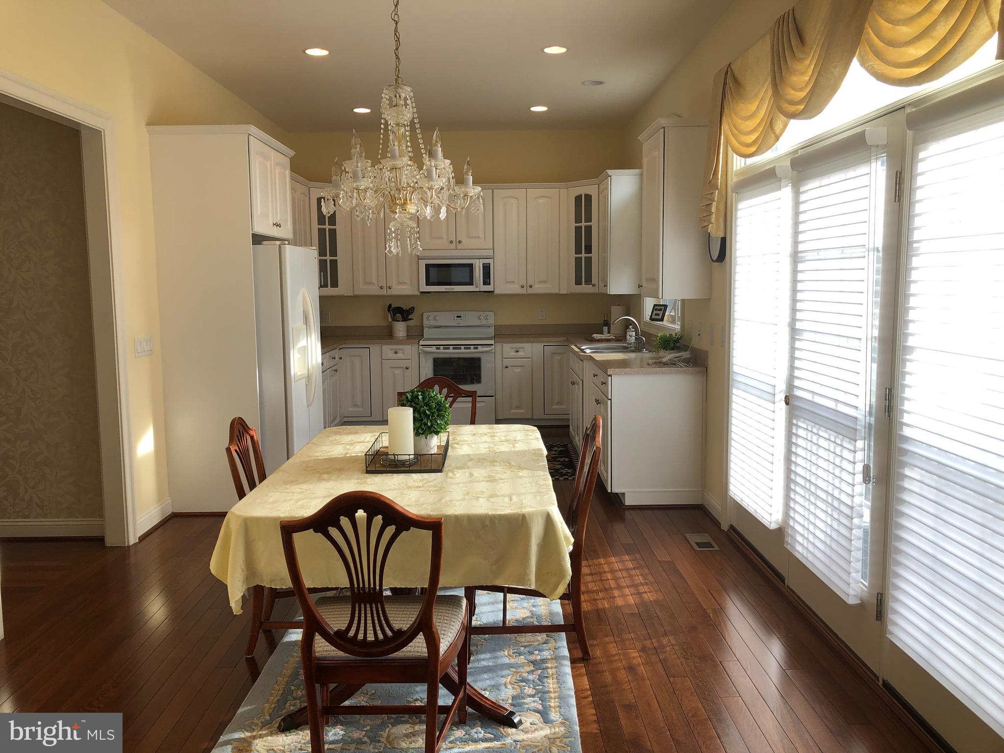 2613 Commander Davis Drive Edgewater, MD 21037 - Photo 8 of 24 a kitchen with a table and chairs in it