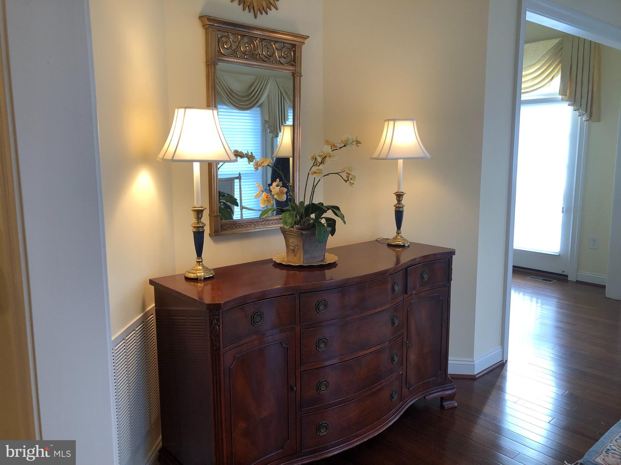 2613 Commander Davis Drive Edgewater, MD 21037 - Photo 10 of 24 a view of a workspace room with wooden floor windows and a chandelier