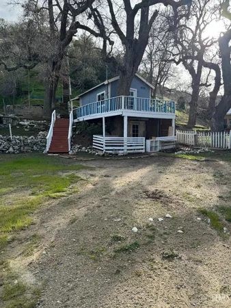 a view of a house with a yard and sitting area
