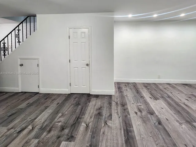 a view of a room with wooden floor and staircase