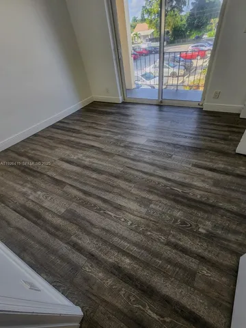 a view of wooden floor with windows