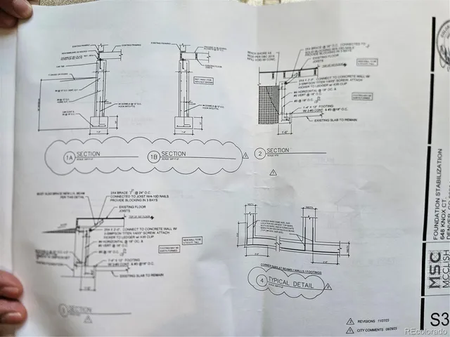 a room with water heater and wooden cabinets