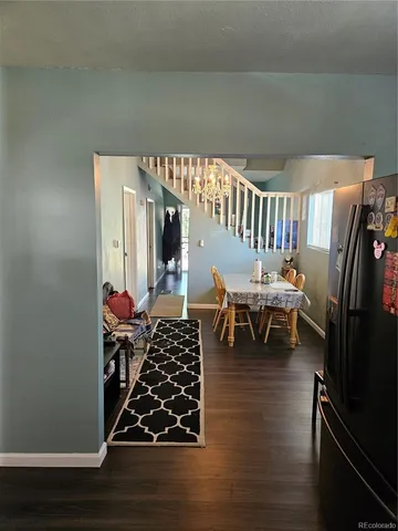 a living room with chairs and a wooden floor
