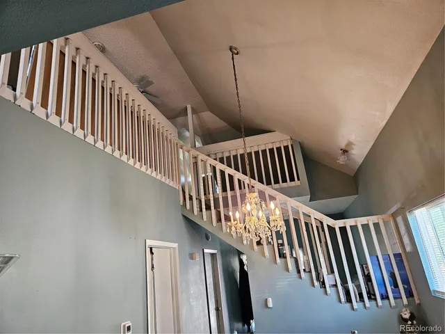 a view of staircase with railing and white walls