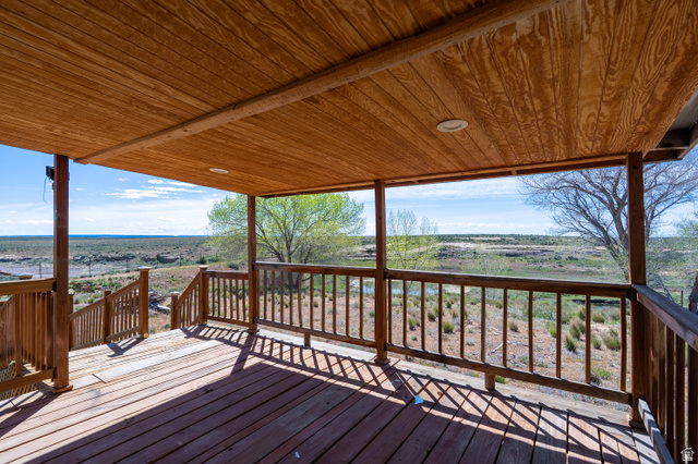 700 East Peter Springs Road Monticello, UT 84535 - Photo 39 of 57 Expansive covered wood deck featuring recessed lighting, a complete railing system, and a scenic natural landscape