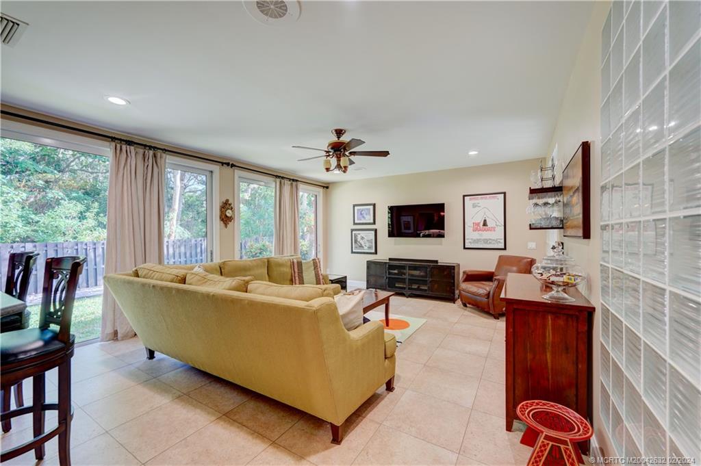 132 South River Road Stuart, FL 34996 - Photo 11 of 45 a living room with furniture and a flat screen tv