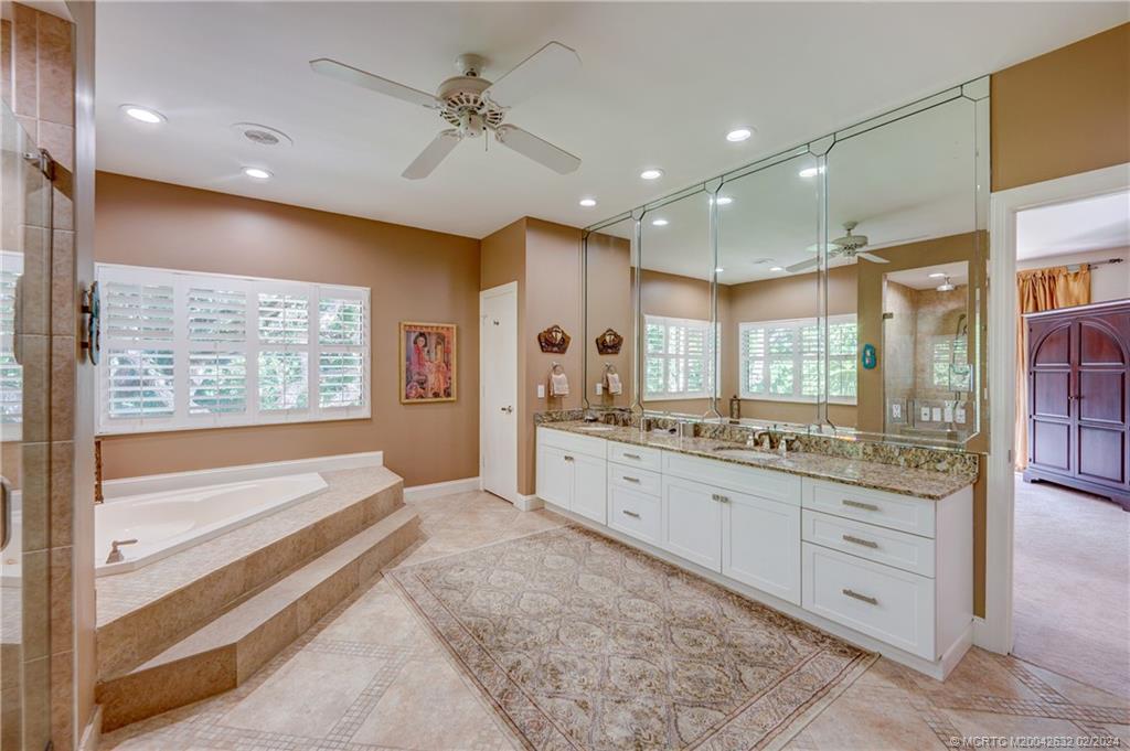 132 South River Road Stuart, FL 34996 - Photo 21 of 45 a large bathroom with a large mirror vanity and a sink