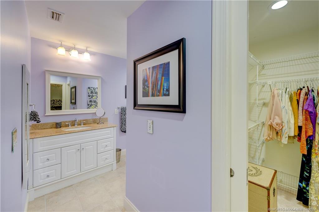 132 South River Road Stuart, FL 34996 - Photo 26 of 45 a bathroom with a double vanity sink and a mirror