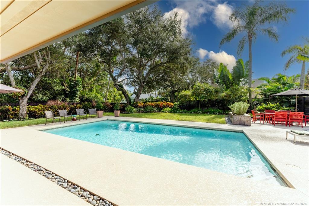 132 South River Road Stuart, FL 34996 - Photo 36 of 45 a view of a swimming pool with a yard