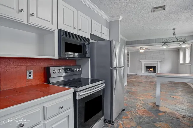 a kitchen with cabinets and steel stainless steel appliances