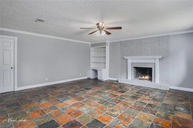 a view of empty room with a fireplace