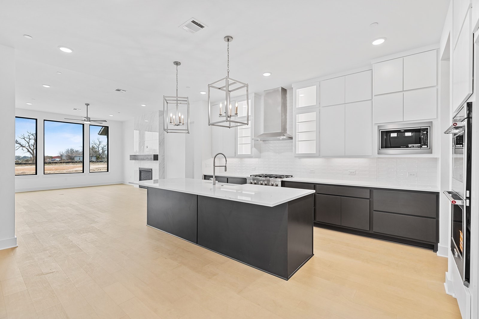 2385 Lineage Lane Leander, TX 78641 - Photo 28 of 36 a large kitchen with stainless steel appliances kitchen island granite countertop a sink and cabinets