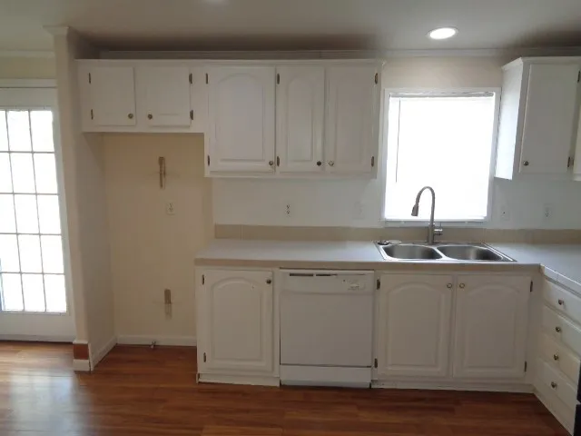 a view of a kitchen with white cabinets