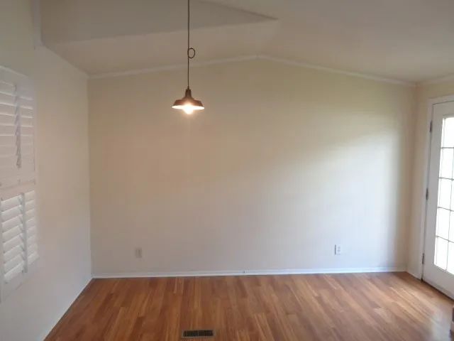 a view of room with window and hardwood floor