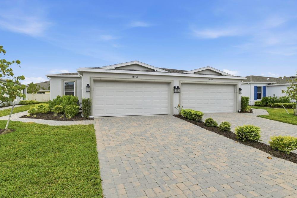 16066 Ivy Ridge Port Charlotte, FL 33953 - Photo 1 of 1 a front view of a house with a garden