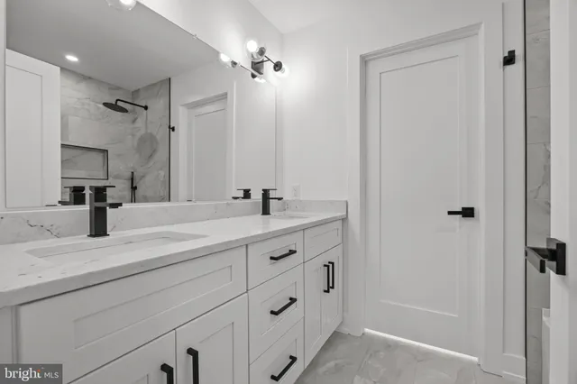 a bathroom with a double vanity sink and mirror