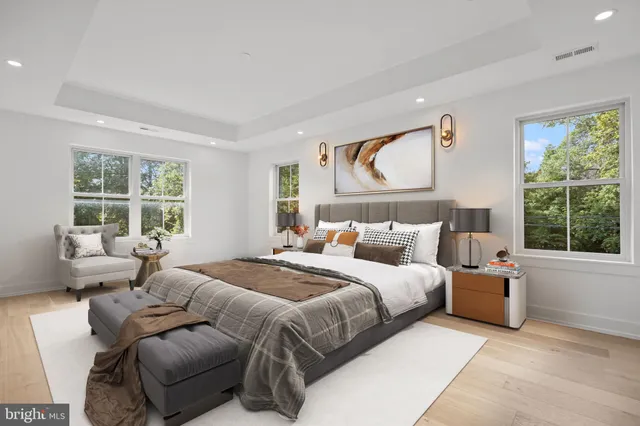 a bedroom with a bed and glass window