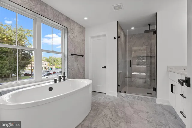 a bathroom with a bathtub and shower