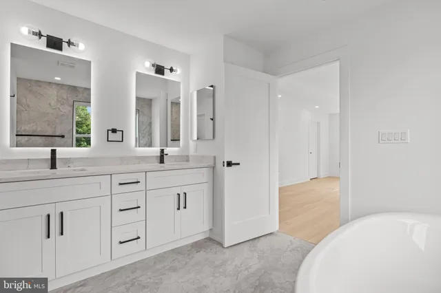 a spacious bathroom with a granite countertop sink a toilet and a mirror
