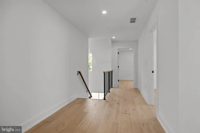 a view of a room with wooden floor