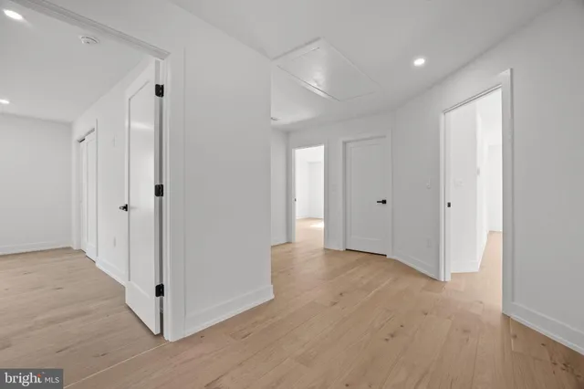 a view of a hallway with wooden floor
