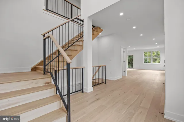 a view of entryway and hall with wooden floor