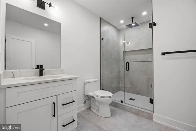 a bathroom with a toilet sink and shower