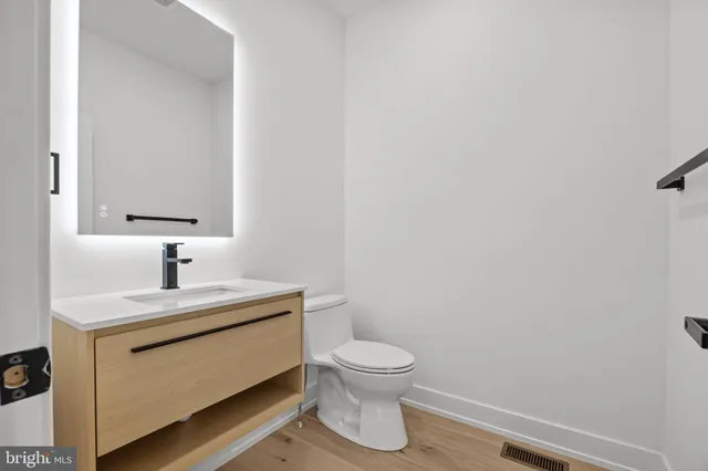 a bathroom with a toilet sink and mirror