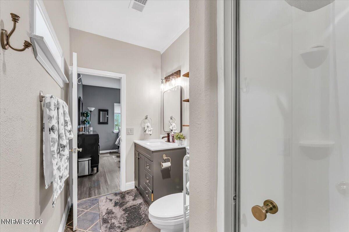 15770 Rocky Vista Road Reno, NV 89521 - Photo 30 of 68 a bathroom with a toilet a sink and shower
