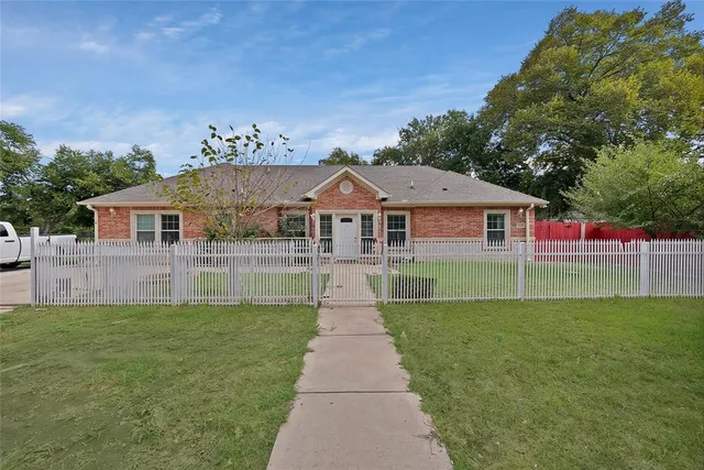 a front view of house with yard and green space