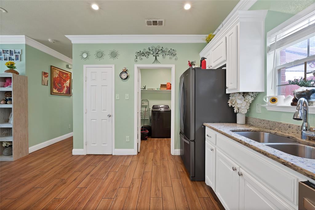 2410 Carleta Street Dallas, TX 75253 - Photo 11 of 29 a kitchen with stainless steel appliances granite countertop a refrigerator and a sink
