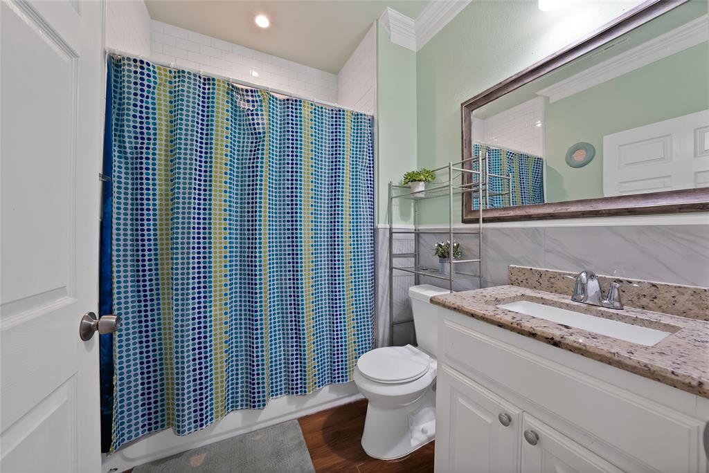 2410 Carleta Street Dallas, TX 75253 - Photo 16 of 29 a bathroom with a granite countertop toilet sink and mirror